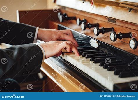 Closeup View On Male Hands In Suit Playing At Pipe Organ In Church