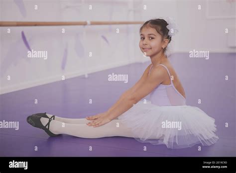 Adorbale Little Ballerina Sitting On The Floor Resting After Ballet