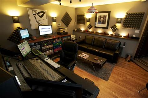 A Recording Studio With Couches Tables And Monitors