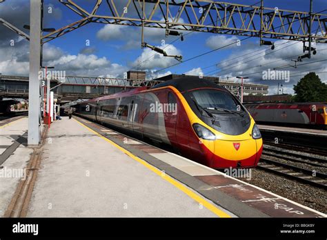 A Virgin West Coast Main Line Train At Stafford Station In Sunlight