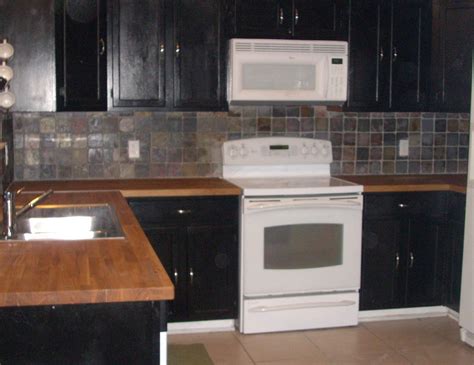 Check out part 1 on lowe's youtube ch. black cabinets with stainless backsplash and butcher block ...