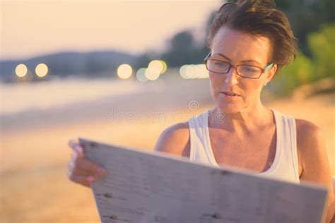 Mature Beautiful Tourist Woman Relaxing At The Beach Stock Image