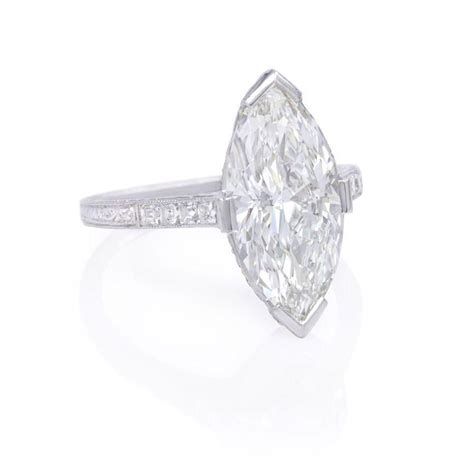 The marquise cut diamond was a popular center diamond in edwardian engagement rings. An Edwardian marquise diamond engagement ring with chased and pierced mount, the undergaller ...