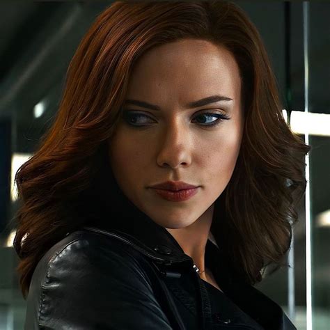 A Woman With Red Hair And Blue Eyes In A Black Leather Jacket Looking