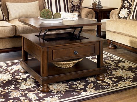 Its top lifts up to give you the perfect higher platform for board games, a puzzle, or tv dinners, while simultaneously revealing hidden storage areas. Porter Rectangular Lift-Top Cocktail Table from Ashley ...