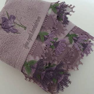 Two Towels With Purple Flowers On Them Sitting Next To Each Other