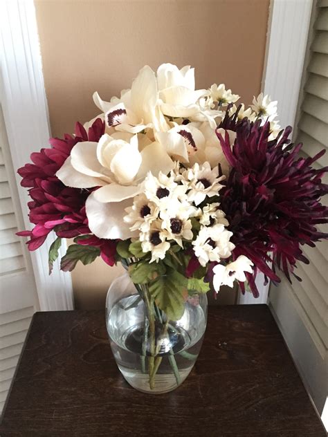This flower arrangement has cascading flowers falling from the hands of the bride. $7 Fall Flowers including Vase! Arrangement of six ...