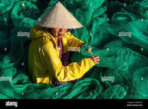 Woman Weaving Fishing Nets Outside Her House In Mui Ne Vietnam Stock
