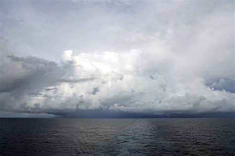 Thunderclouds And Rain Clouds Over The Sea Horizon And The Surface Of