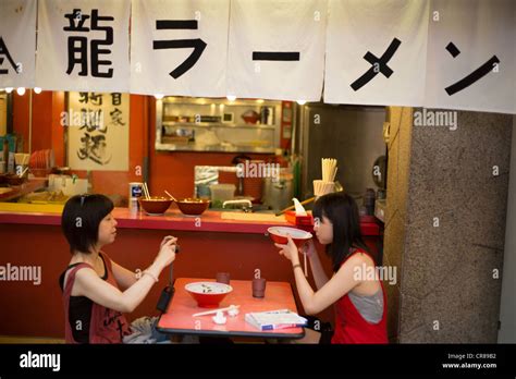 Two Women Eating Ramen Noodles In Dotonbori In Osaka Kansai Region