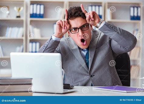 The Funny Businessman Clown Acting Silly In The Office Stock Image