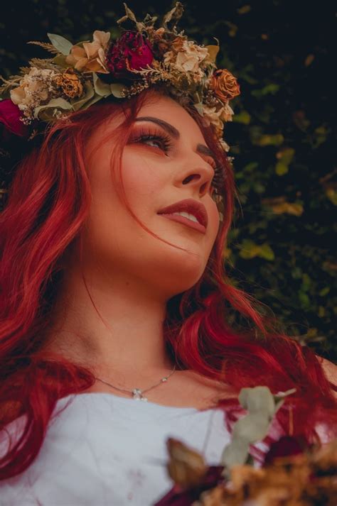 A Woman With Red Hair Wearing A Flower Crown
