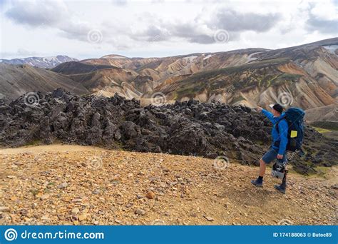 Hiker With Backpack In The Landmannalaugar Valley Iceland Colorful