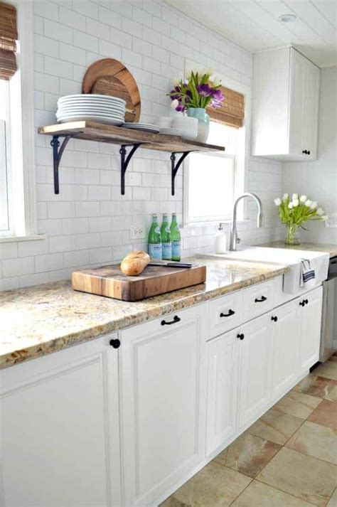 However, in my opinion (if your kitchen is small), painting the cabinets a creamy white (warm white to blend with the pink/tan) will make the kitchen appear larger as it'll give a more seamless look. Choosing the Best White Paint Color for Your Kitchen Cabinets