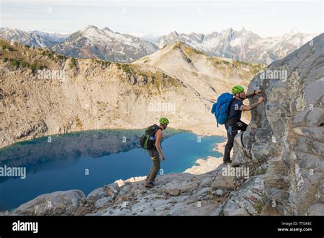 Climbers Scramble A Rocky Ridge On Douglas Peak Bc Stock Photo Alamy