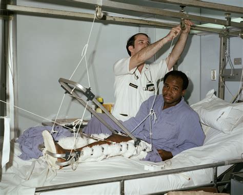 Most people who have hip fractures will need hip surgery. First Lieutenant John E. Robinson adjusts the traction apparatus for a patient with a fracture ...