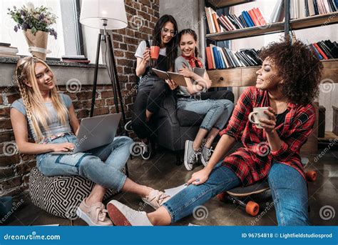 Smiling Young Women Sitting Together With Laptop And Coffee Cups Stock