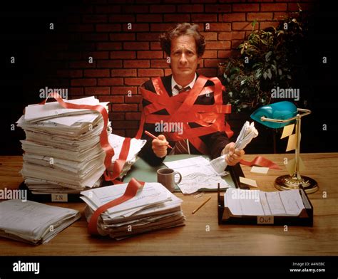 Businessman Tied Up In Red Tape Stock Photo Alamy