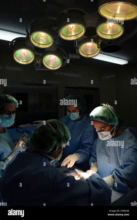 Doctors Performing Gynecological Surgery In Operating Room Stock Photo