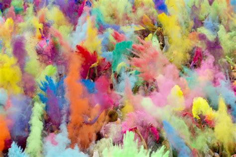 People Throw Coloured Powder In The Air During Holi Festival