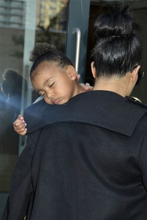 kim kardashian carries a sleeping north west in her arms kim kardashian and north kim and kanye