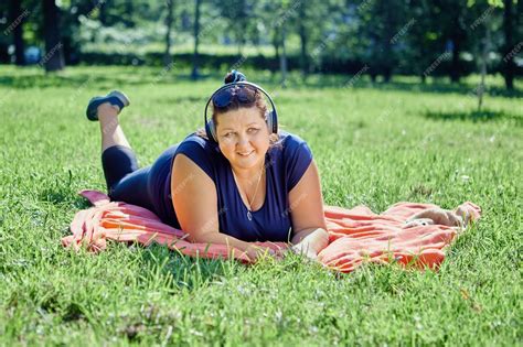Premium Photo Fat Woman Is Resting On Lawn Lying On Her Stomach