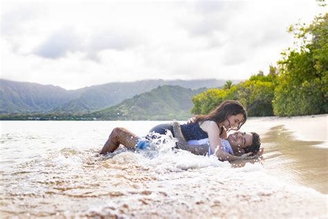 Couple Get Wet While Laying On The Sand Ans Water Crashes On … Hawaii Engagement Photography