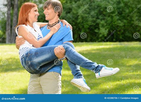 Teenage Boyfriend Carry Girlfriend In His Arms Stock Photo Image