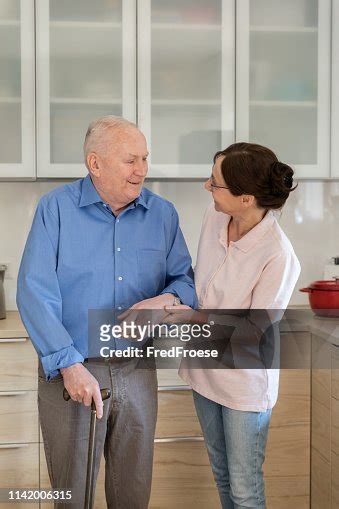 Home Caregiver Woman Helping Senior Man High Res Stock Photo Getty Images
