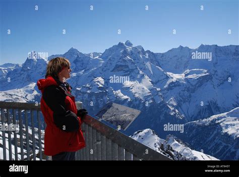 Tourist Viewing Bernese Alps In Winter From Schilthorn Switzerland