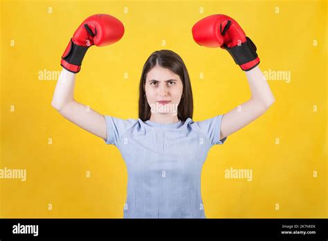 Confident Young Woman With Red Boxing Gloves Celebrating Success