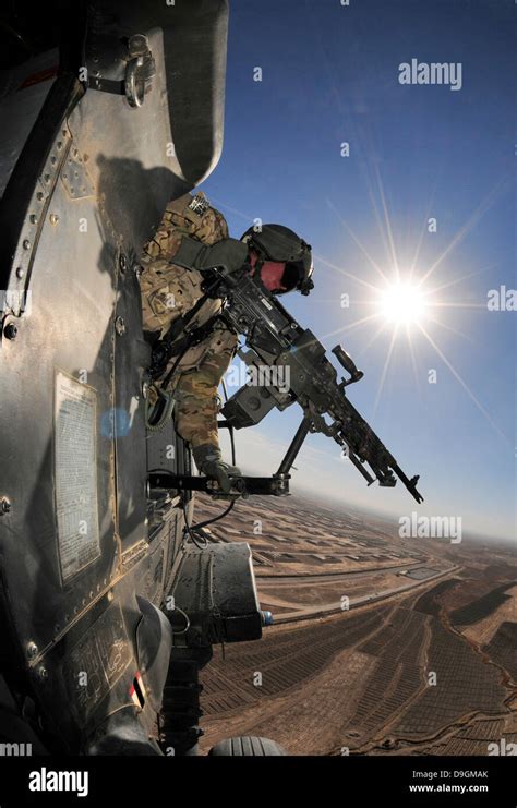 A Us Army Door Gunner With The 25th Infantry Division Scans For