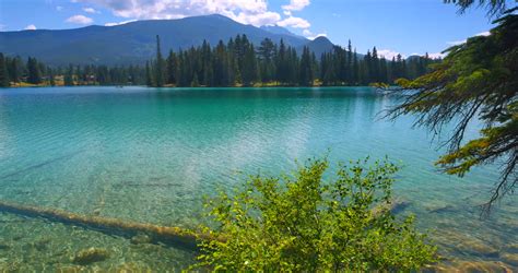 Stock Video Of Crystal Clear Lake Sun And Mountains