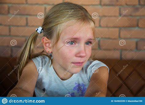 Blond Crying Teen Girl With Long Hair And Blue Eye Stock