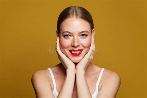 Beautiful Woman Holding Her Cheeks In Her Hands On Yellow Background Stock Image Image Of