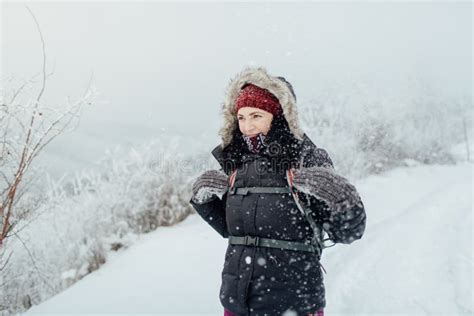 Smiling Woman Dressed Warm Enjoying A Walk In Snowy Country Stock Image