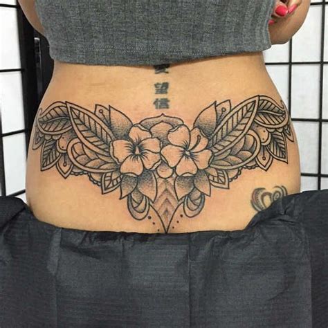 The pink and black also go well together. pretty flower back tattoos - Google Search | Cover up ...