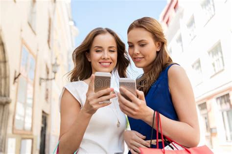 Happy Women With Shopping Bags And Smartphones Stock Image Image Of