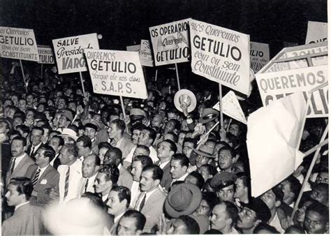 A Large Group Of People Holding Up Signs