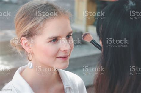 Makeup Artist Hand Working With Beautiful Young Woman Applying Makeup For Female Model Face