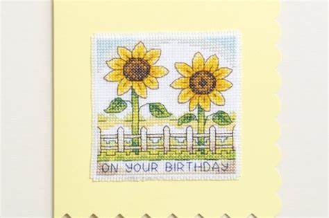 Shows finished pattern on 14 count aida in green bright colourful bouquet of sunflowers with the word mum underneath. Free Sunflower Cross Stitch Pattern - Gathered
