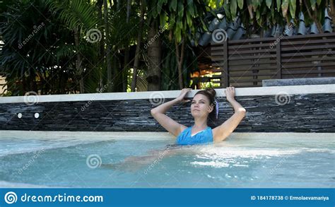 Beautiful Young Woman Relaxes In A Hydromassage Jacuzzi In Swimming