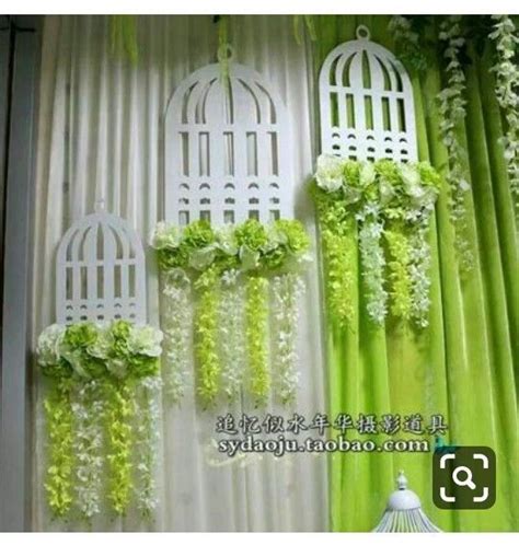 Green And White Curtains With Flowers Hanging From Them