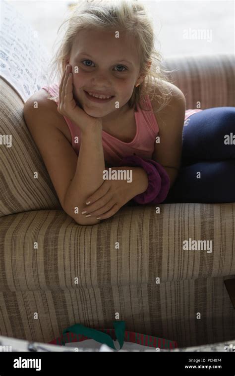 Pretty 8 Year Old Blonde Looking At Camera With Big Smile Resting