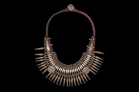 An Old Ladakh Silvered Metal Traditional Patterned Drops Necklace On A