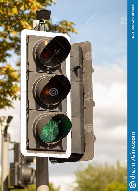 Vertical Shot Of Traffic Light Post Showing Green Stock Photo Image