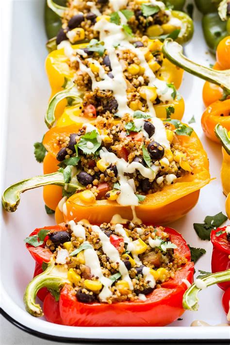 these tasty mexican inspired quinoa stuffed peppers are a hearty plant based meal for an