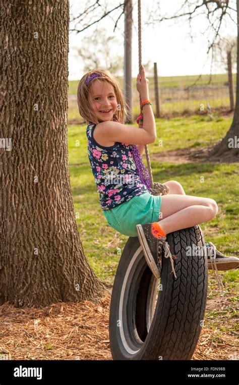 Smiling Preteen Girl On Tire Swing Stock Photo Alamy