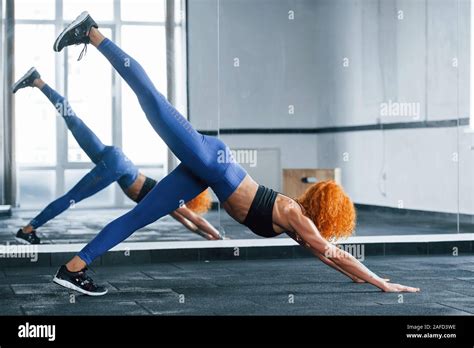 Against The Mirror Sporty Redhead Girl Have Fitness Day In Gym At Daytime Muscular Body Type