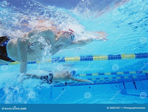 Underwater Shot Of Three Male Athletes In Swimming Competition Stock